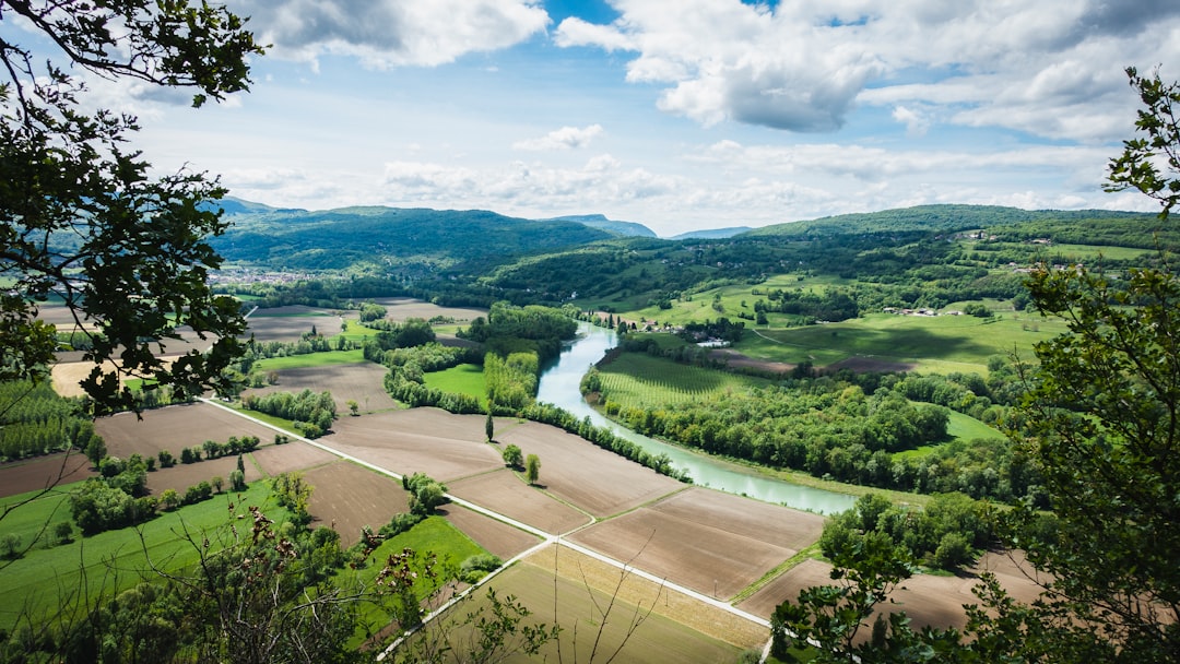 panoramic view of french countryside with fields and river, landscape photography, unsplash style, in the style of unsplash. –ar 16:9