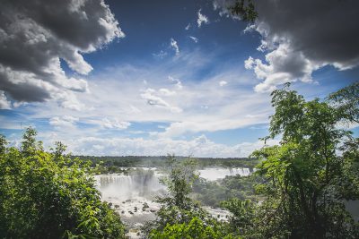 IguSVG style photo of Iguazu Falls from the top, beautiful clouds and sky, trees, shot in the style of Sony Alpha A7 III. --ar 128:85