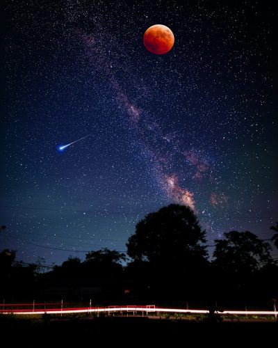 In the night sky, there is an eclipse and a red moon hanging in front of it. The Milky Way stretches across the starry background with its silver light, while a shooting star shines on top of trees next to a country road. This scene has high resolution, wide angle lens, long exposure effect, starlight reflection, sharp contrast between colors, and spectacular scenery. It presents mystery, tranquility, grandeur, beauty, and wonderland in the style of mystery, tranquility, grandeur, beauty, wonderland. --ar 51:64