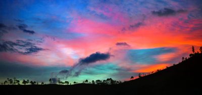 Beautiful colorful sky at sunset with black silhouette of hillside, Indonesian landscape, wide angle, panoramic view, award winning photography. The landscape was in the style of Indonesian scenery with a wide and panoramic view of the colorful sky at sunset and the black silhouette of the hillside. --ar 32:15