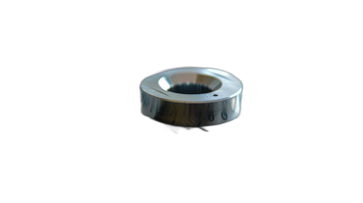 A photo of an aluminum nut with a chrome finish, on a black background, shot from above in macro photography with studio lighting. The photo is in the style of studio macro photography.