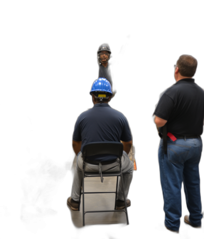 photorealistic photo of construction worker sitting on folding chair, facing camera with blue helmet and safety glasses in hand while standing up next to him is another man wearing jeans and black shirt talking about something to the seated one, black background, 35mm lens, f/2.8